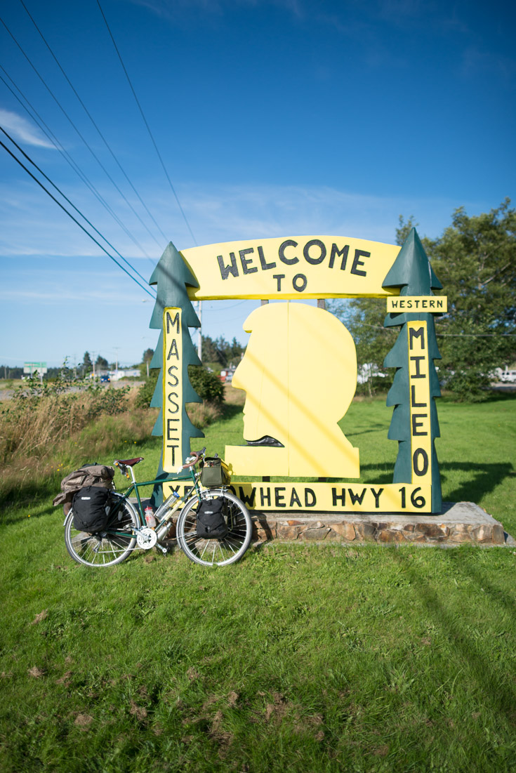 And then my photos jump to mile zero of the Yellowhead Highway where the sun is shining, the road is paved, and the bike is clean - what was left undocumented in between is a blurry memory of a nightmare. Coming back out of Rennell Sound on the logging roads proved to be a daunting challenge. The nasty weather had turned the logging roads into soft thick mud slicks which made the riding absolutely miserable. At one point we were at a standstill, slipperily trying to push our heavy bikes up that steepest section of road (oh 25%…not so pretty when your body won’t work anymore) when a feller (a logger who cuts trees down) finishing his shift out there happily let us throw our bikes in the back of his truck and hitch a ride up the worst of it. He dropped us at the main line - him continuing south to Queen Charlotte City where we started and us pointing our filthy rides north to Port Clements. Even back on the main road, mud was constantly jamming up my front wheel and crusting over both our bikes like cement. The quarks and sounds our bikes were making when we finally hit pavement again was unnerving. This was another really long day of riding in tough conditions into the twilight. The kitchen in the Port Clements pub was closed when we finally stumbled through its doors, but the bartender took pity on us and threw together a pizza sub and nachos for our hungry bellies. It’s amazing how absolutely anything tastes so delicious when you’re that hungry. Someone palmed us each a Budweiser as we squeaked into camp that night and that was as good as any craft beer could have been at that moment, and that moment only. Needless to say, I did not take my camera out once on this day. Welcome to Masset!