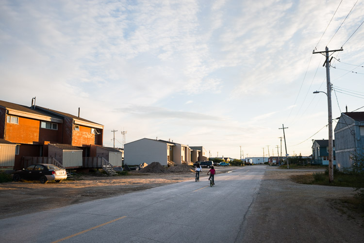 Children cycle down the quiet streets of the remote northern town.