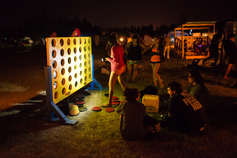 A couple plays a game of Connect Four at Big Games in the festival campground.