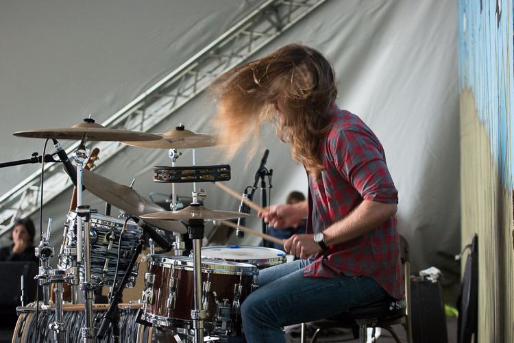 When the initial blast of storm winds hit, seven of us jumped up to brace the backdrop (pictured here behind the drummer) as the band finished what would be their last song. Music was put on hold until the storm warning passed 30 minutes later. This drummer from The Wooden Sky was eager to drum up a storm just after the storm.