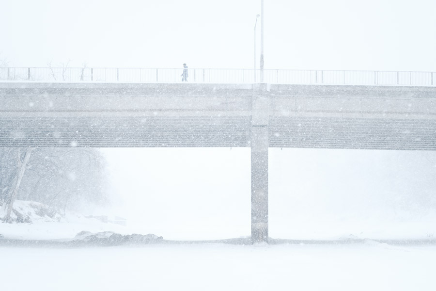 A snowy silhouette crosses the bridge.